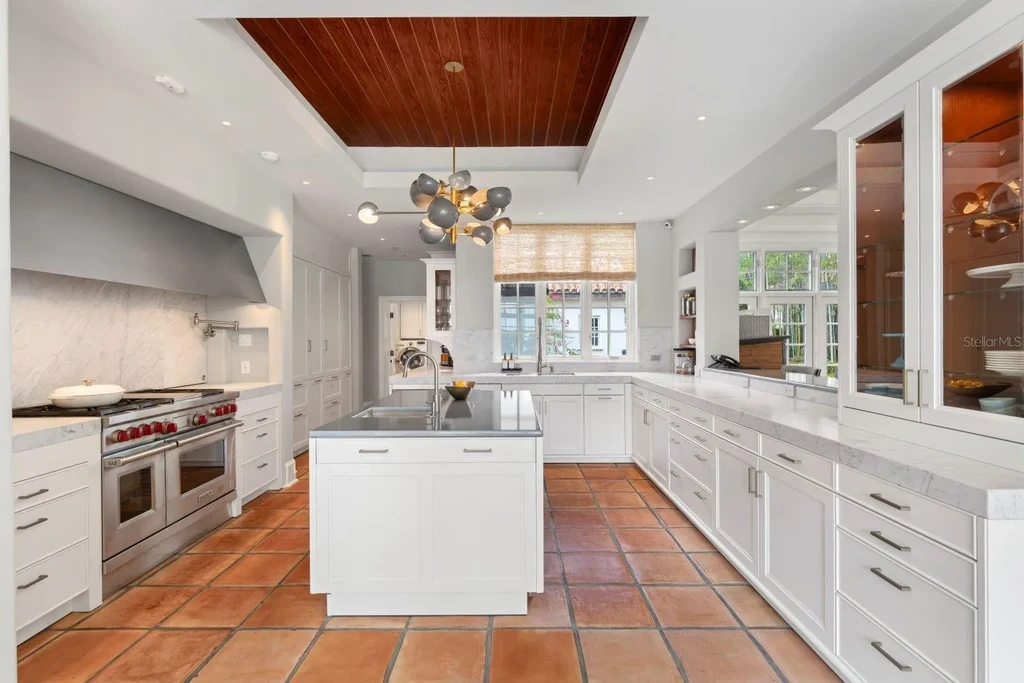 Luxurious Mediterranean estate at 1640 E Adams Dr in Maitland, featuring a grand motor court and lush landscaping