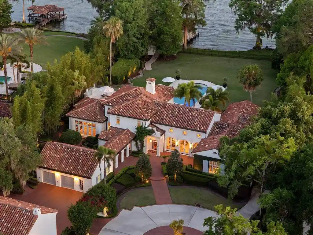 Luxurious Mediterranean estate at 1640 E Adams Dr in Maitland, featuring a grand motor court and lush landscaping