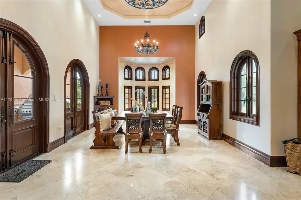 Elegant living room with high ceilings and Crestron smart home system at 17201 SW 248th St in Homestead, FL