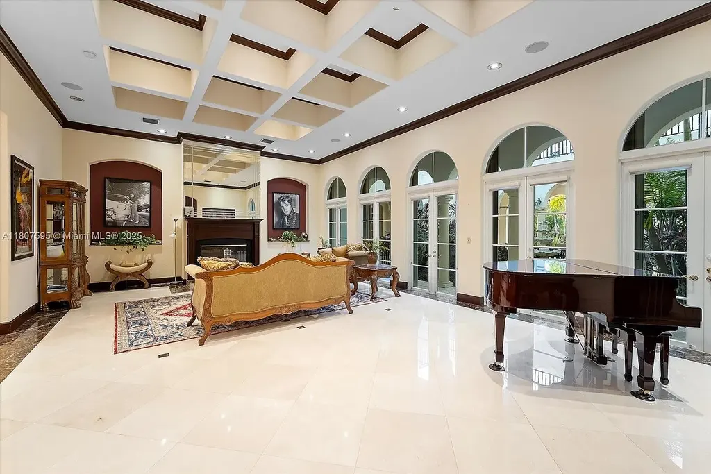 Front aerial view of 18451 SW 158th St luxury home in Miami featuring Mediterranean architecture, saltwater pool, private airstrip, and horse stables