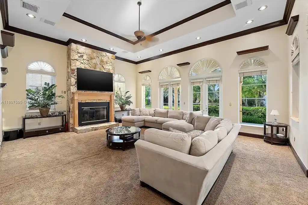 Front aerial view of 18451 SW 158th St luxury home in Miami featuring Mediterranean architecture, saltwater pool, private airstrip, and horse stables