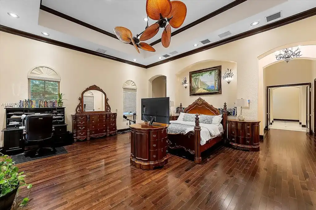 Front aerial view of 18451 SW 158th St luxury home in Miami featuring Mediterranean architecture, saltwater pool, private airstrip, and horse stables