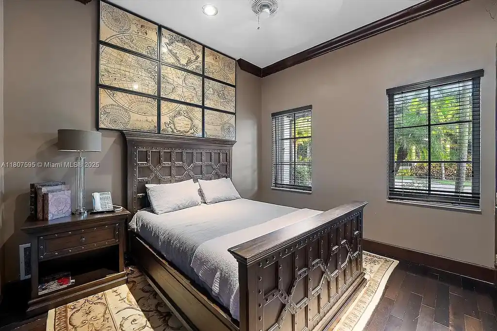 Front aerial view of 18451 SW 158th St luxury home in Miami featuring Mediterranean architecture, saltwater pool, private airstrip, and horse stables