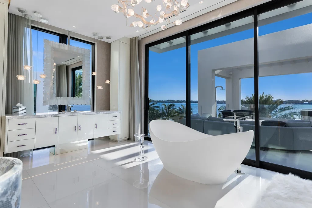 Front view of the $84.9M luxury mansion at 1940 S Ocean Boulevard in Manalapan, Florida, featuring oceanfront design, infinity pool, and private dock access.