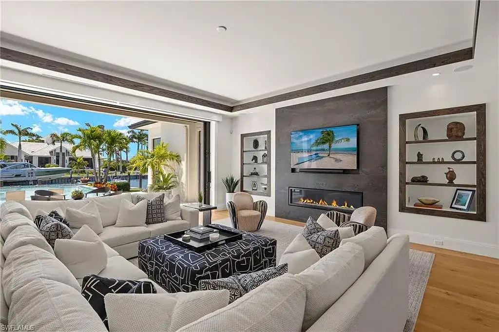 Front exterior view of 2500 Tarpon Rd Naples, a $11.995M modern coastal home for sale in Royal Harbor featuring canal frontage, luxury design, and saltwater pool