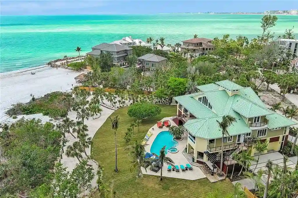 Luxury Gulf-front estate with private beach access and panoramic ocean views at 26 Sandy Hook Rd S, a high-end Sarasota home for sale.