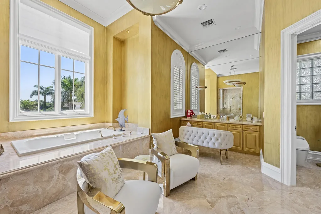 Courtyard estate at 319 Mizner Lake Estates Drive in Boca Raton, FL, featuring lakefront views, guest house, pool, and access to Boca Raton Resort amenities.