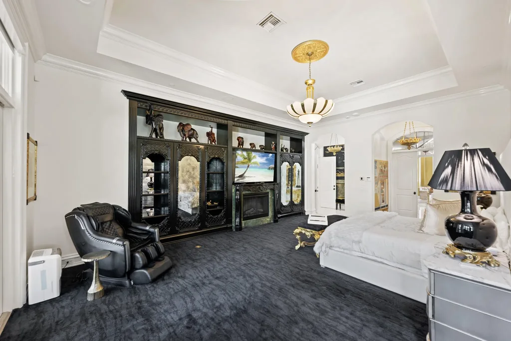 Courtyard estate at 319 Mizner Lake Estates Drive in Boca Raton, FL, featuring lakefront views, guest house, pool, and access to Boca Raton Resort amenities.