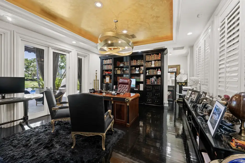 Courtyard estate at 319 Mizner Lake Estates Drive in Boca Raton, FL, featuring lakefront views, guest house, pool, and access to Boca Raton Resort amenities.
