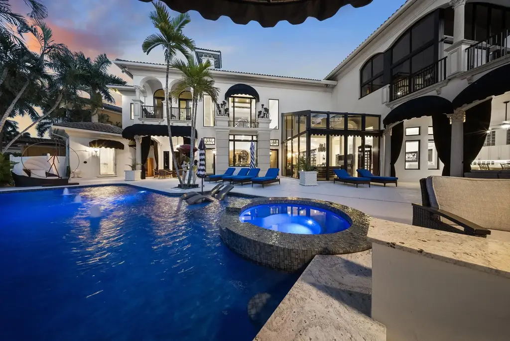 Courtyard estate at 319 Mizner Lake Estates Drive in Boca Raton, FL, featuring lakefront views, guest house, pool, and access to Boca Raton Resort amenities.