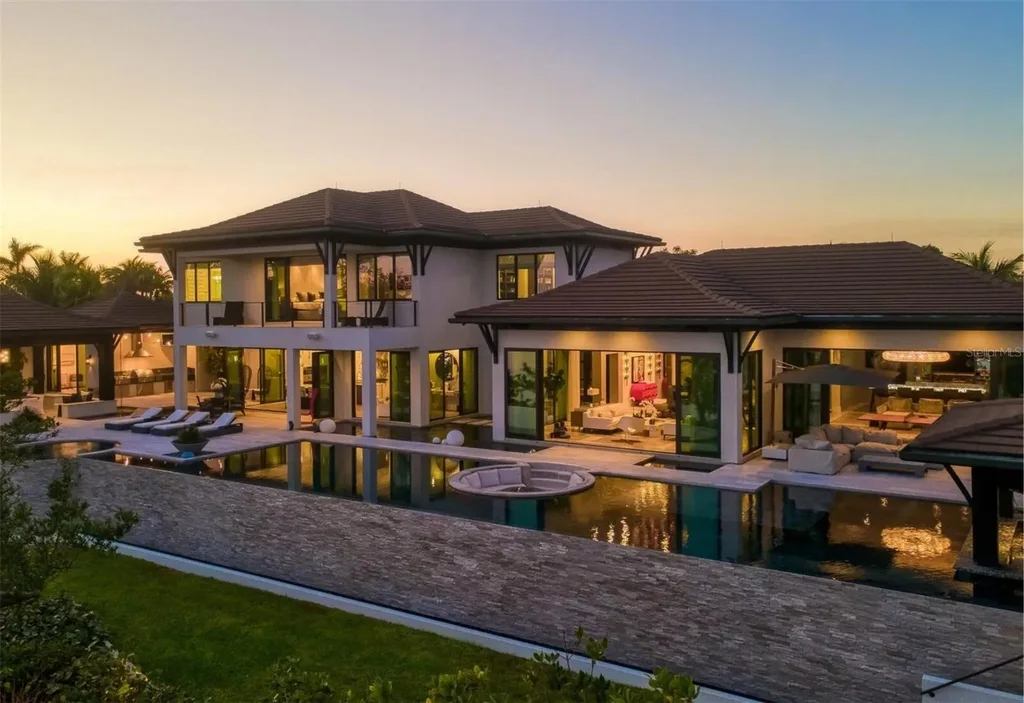 Balinese-inspired luxury waterfront estate at 3799 Flamingo Ave, Sarasota featuring infinity pool, koi pond, and tropical modern design