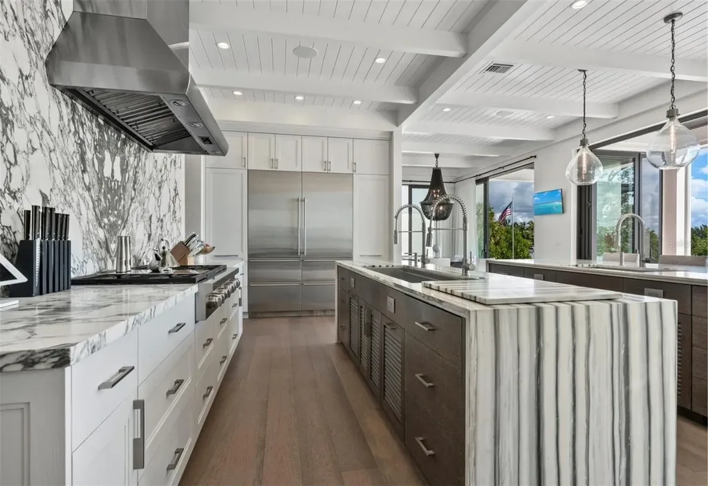 Balinese-inspired luxury waterfront estate at 3799 Flamingo Ave, Sarasota featuring infinity pool, koi pond, and tropical modern design