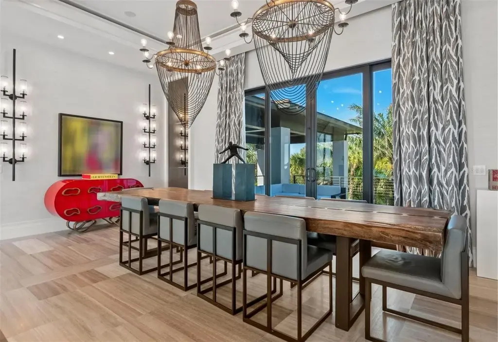Balinese-inspired luxury waterfront estate at 3799 Flamingo Ave, Sarasota featuring infinity pool, koi pond, and tropical modern design
