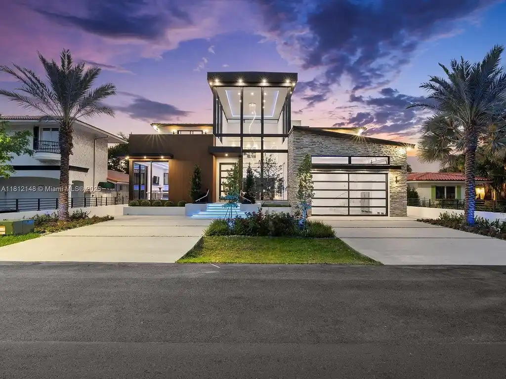 Aerial view of 401 Bontona Ave showcasing private dock, heated pool, and 75 feet of deep-water frontage