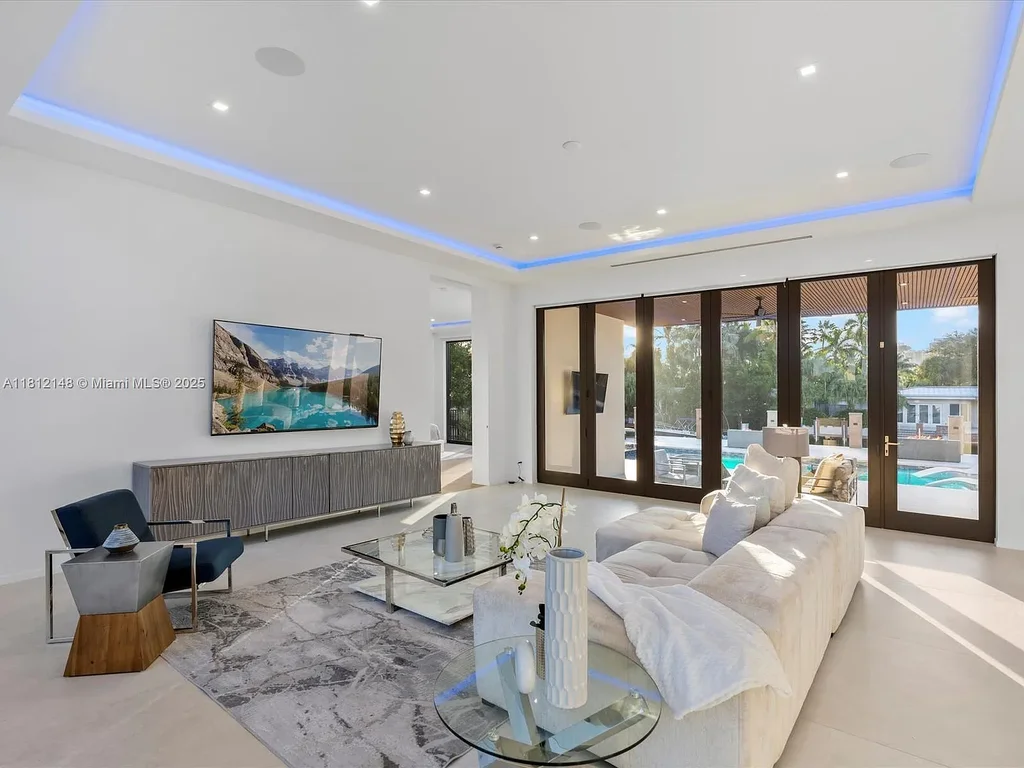 Aerial view of 401 Bontona Ave showcasing private dock, heated pool, and 75 feet of deep-water frontage