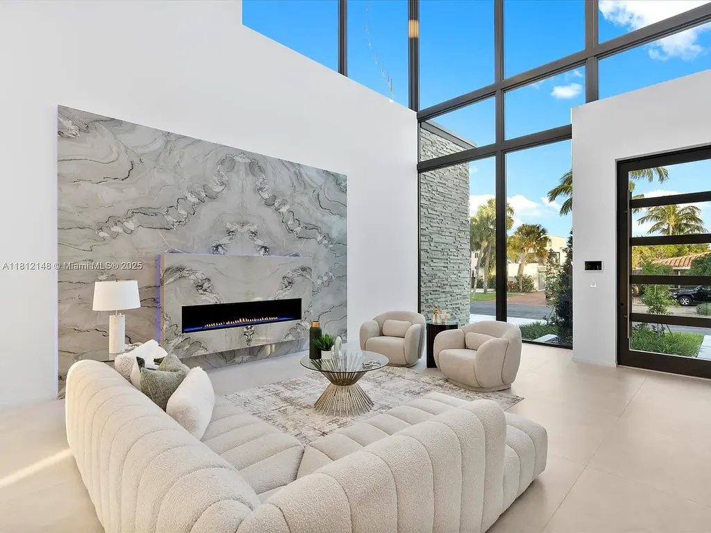 Aerial view of 401 Bontona Ave showcasing private dock, heated pool, and 75 feet of deep-water frontage