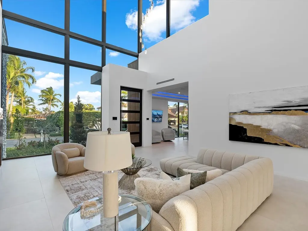 Aerial view of 401 Bontona Ave showcasing private dock, heated pool, and 75 feet of deep-water frontage