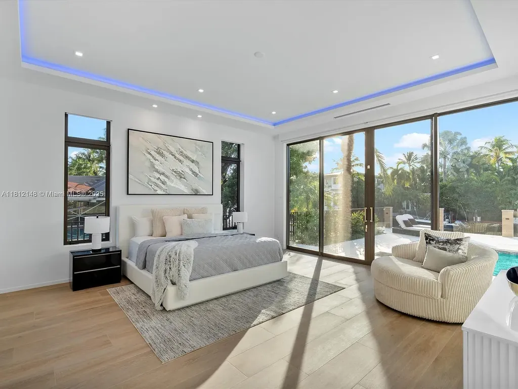 Aerial view of 401 Bontona Ave showcasing private dock, heated pool, and 75 feet of deep-water frontage