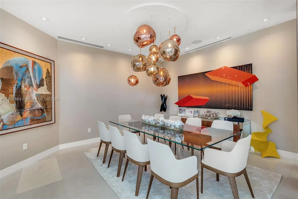 Modern waterfront home at 420 Island Dr in Key Biscayne with lush landscaping and canal view