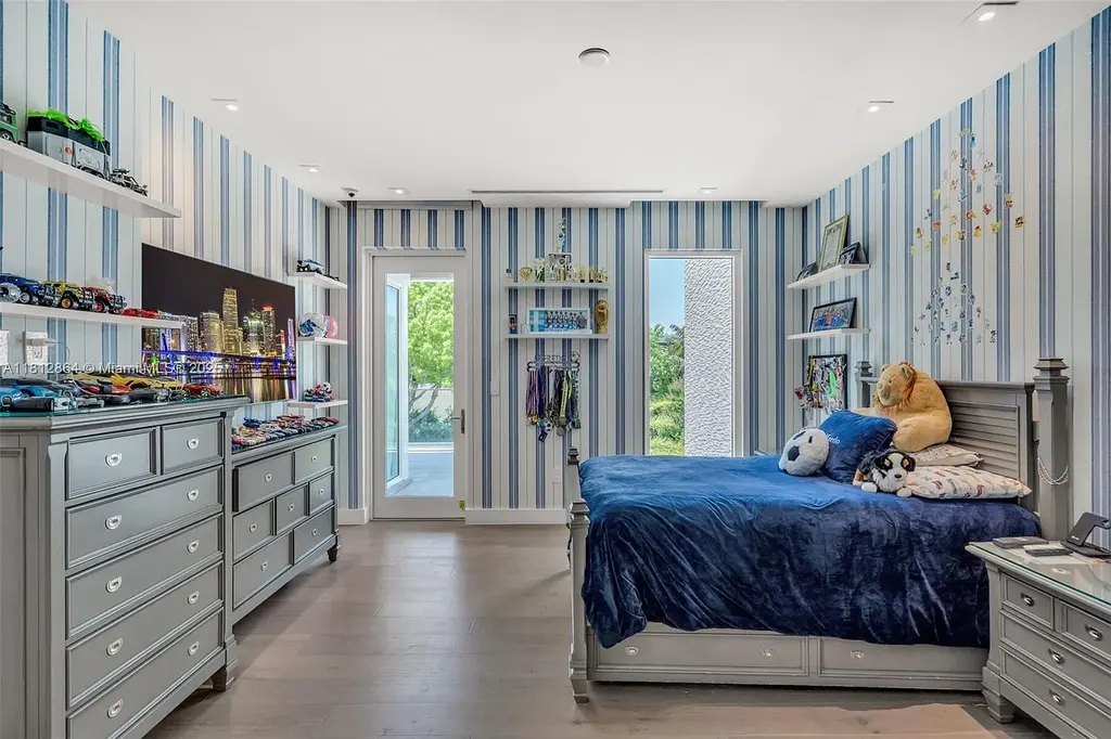 Modern waterfront home at 420 Island Dr in Key Biscayne with lush landscaping and canal view