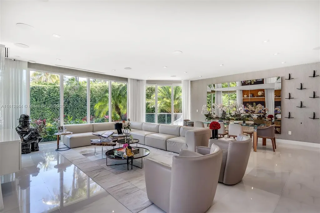 Modern waterfront home at 420 Island Dr in Key Biscayne with lush landscaping and canal view