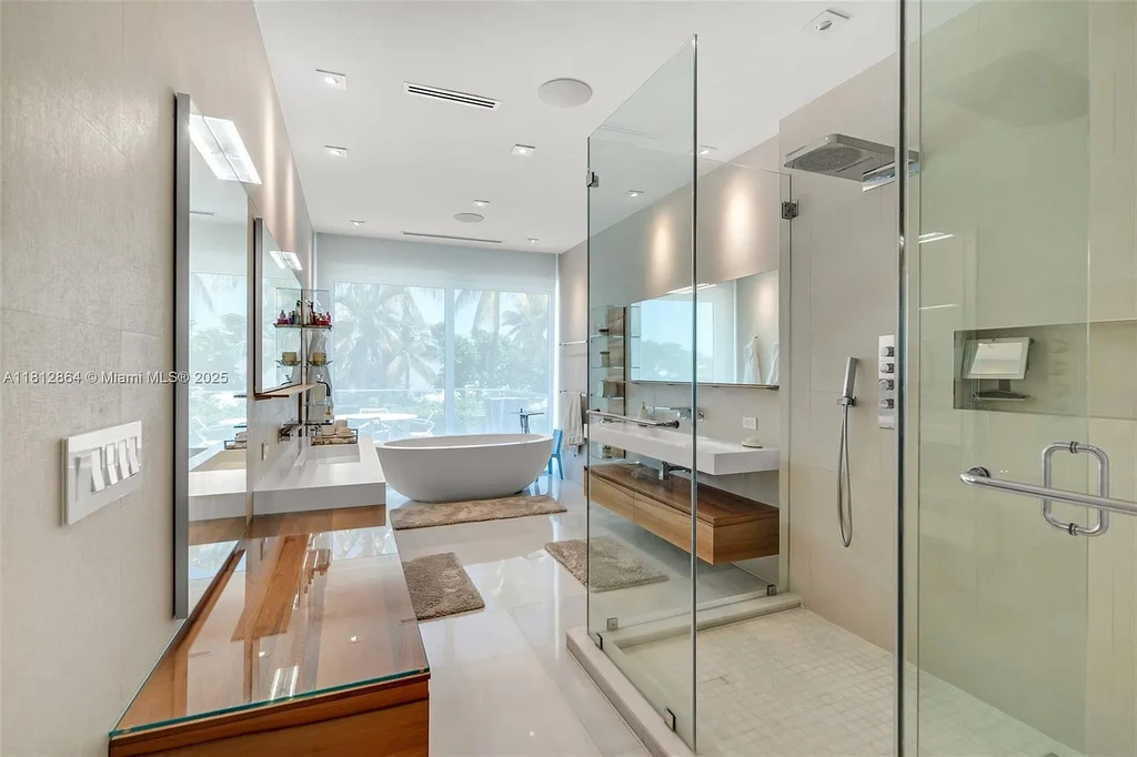Modern waterfront home at 420 Island Dr in Key Biscayne with lush landscaping and canal view