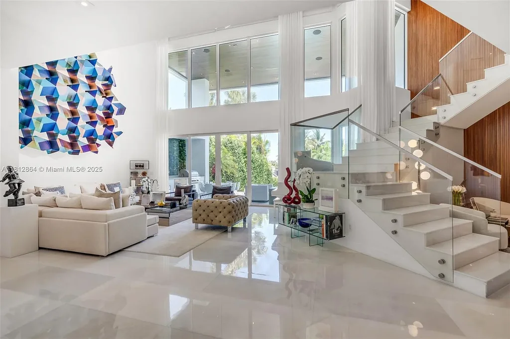 Modern waterfront home at 420 Island Dr in Key Biscayne with lush landscaping and canal view