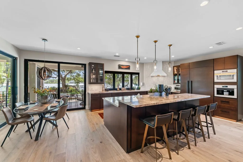 Waterfront estate at 5488 Pennock Point Road, Jupiter, Florida – featuring private dock, pool, and lush landscaping