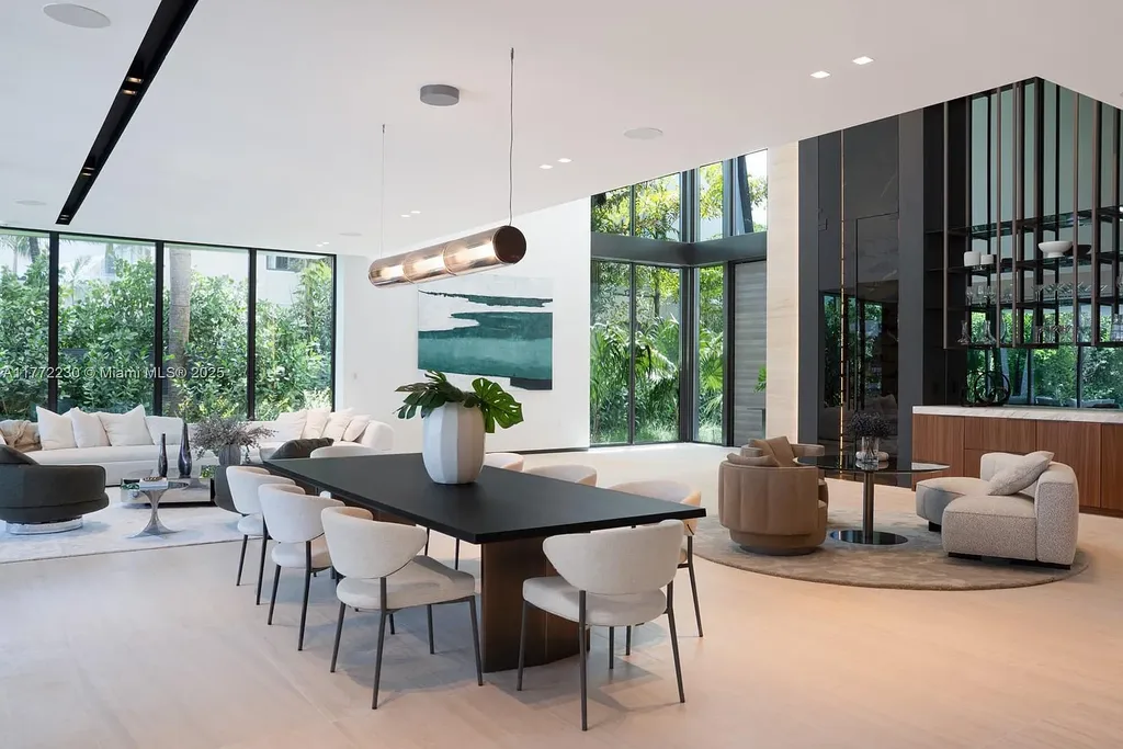 Spacious living room featuring Minotti furnishings, floating staircase, and soaring ceilings in luxury Miami Beach home for sale