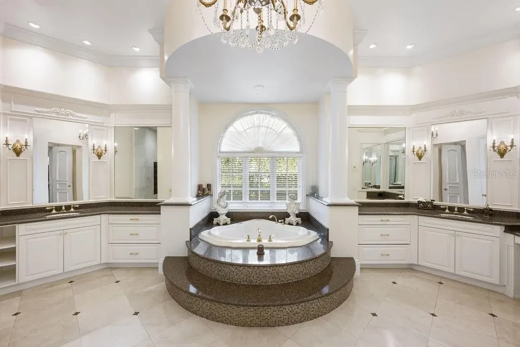 Lakefront luxury estate at 6139 Greatwater Dr in Windermere, featuring saltwater pool, summer kitchen, and panoramic views of Lake Tibet.