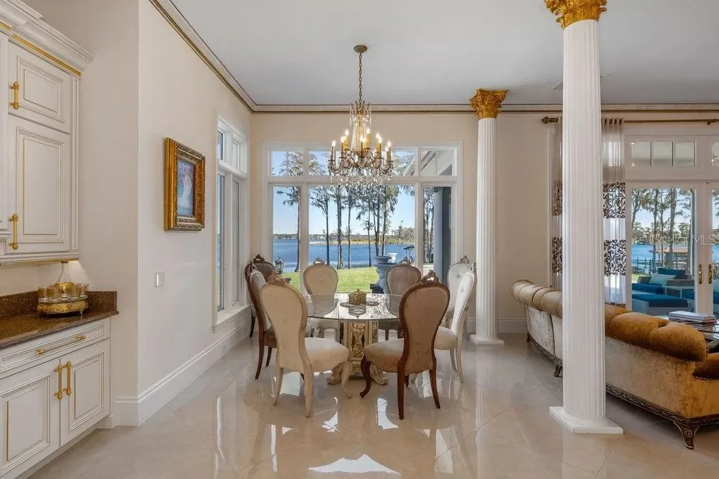 Lakefront luxury estate at 6139 Greatwater Dr in Windermere, featuring saltwater pool, summer kitchen, and panoramic views of Lake Tibet.