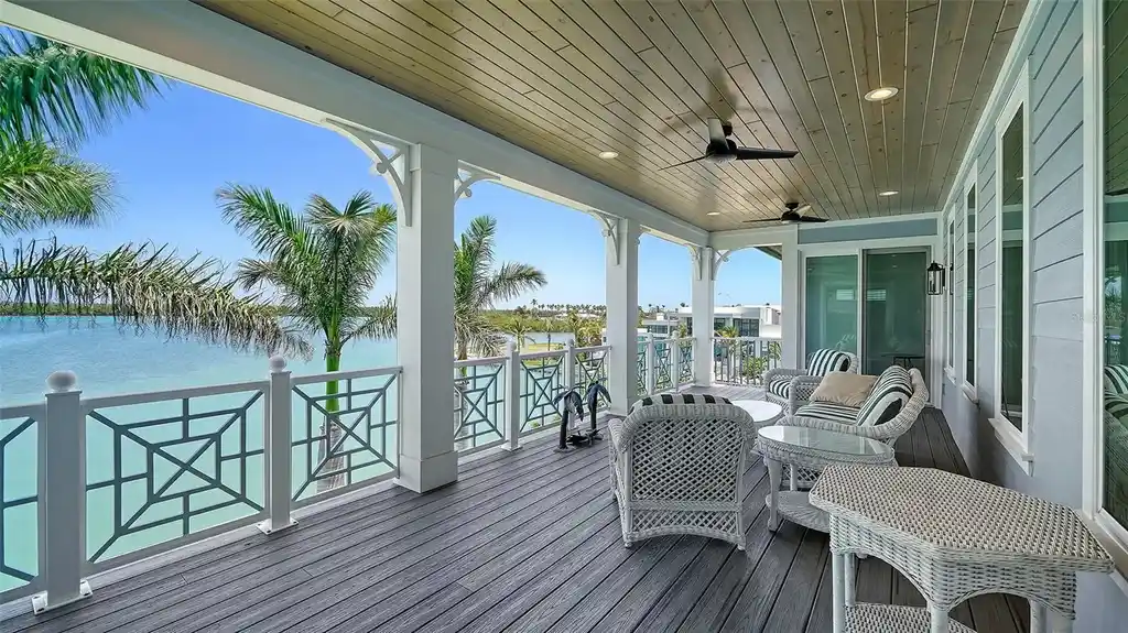 Aerial view of 630 De Narvaez Dr, a luxury bayfront estate in Longboat Key with 880 feet of private shoreline and resort-style pool