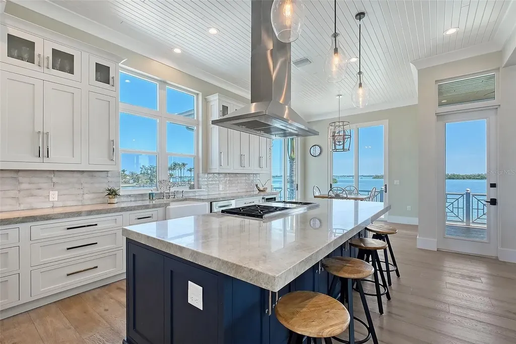 Aerial view of 630 De Narvaez Dr, a luxury bayfront estate in Longboat Key with 880 feet of private shoreline and resort-style pool