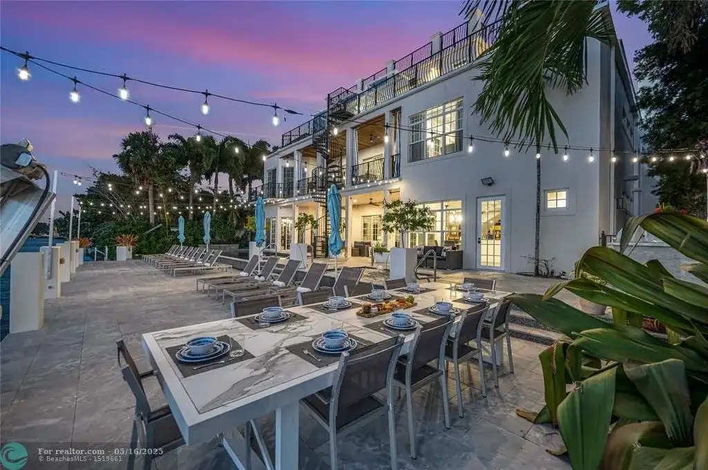 Front view of 1317 Middle River Dr showcasing sleek modern design and tropical landscaping in Fort Lauderdale