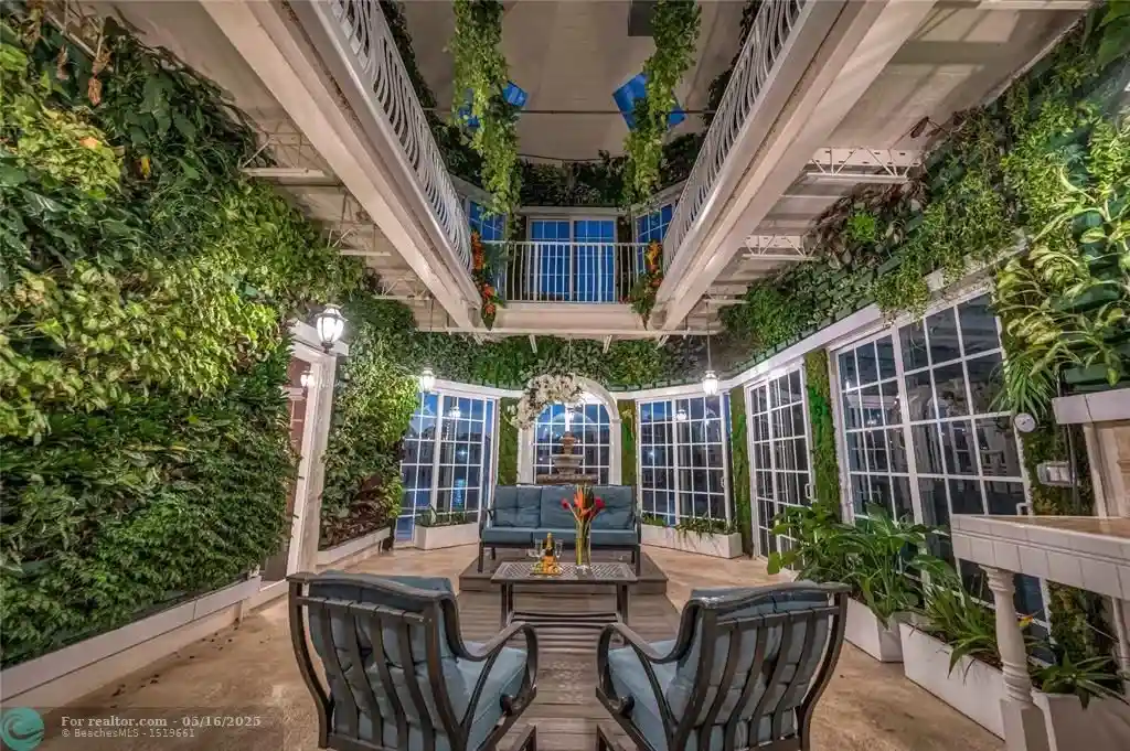 Front view of 1317 Middle River Dr showcasing sleek modern design and tropical landscaping in Fort Lauderdale