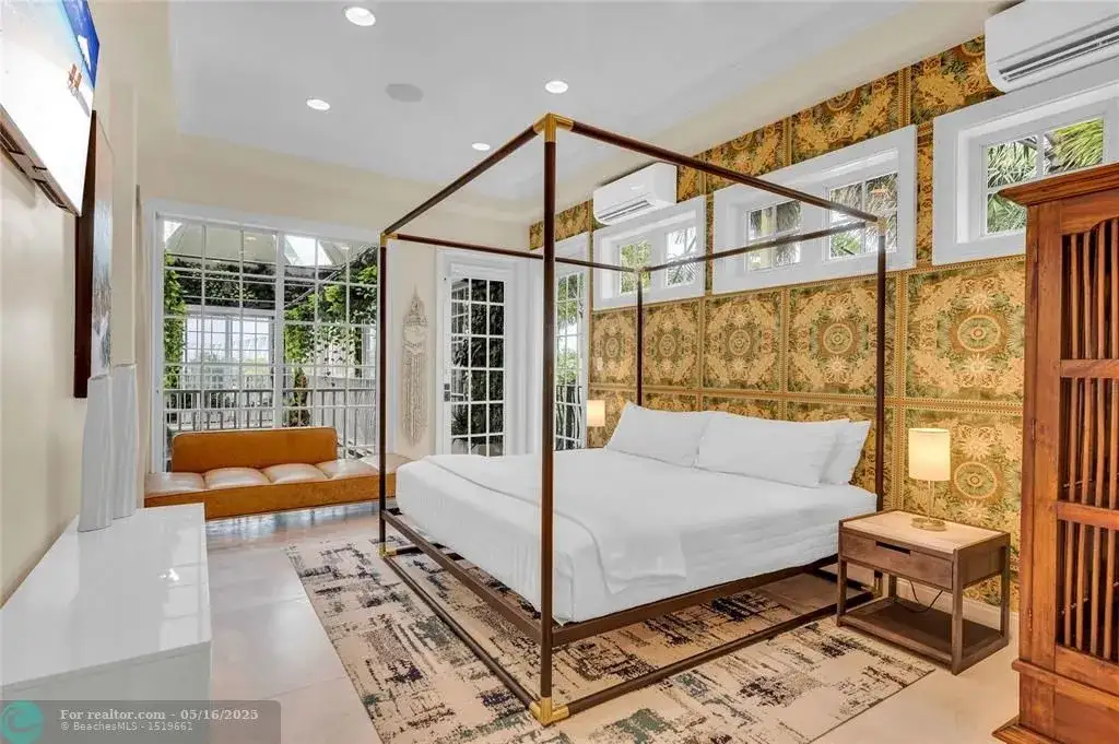 Front view of 1317 Middle River Dr showcasing sleek modern design and tropical landscaping in Fort Lauderdale