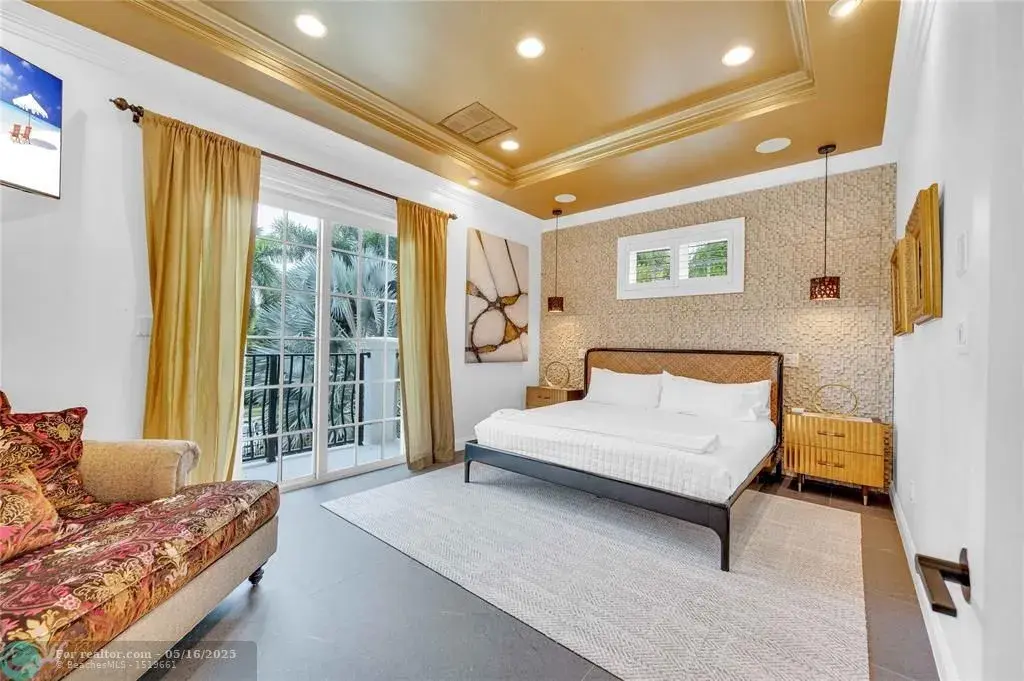 Front view of 1317 Middle River Dr showcasing sleek modern design and tropical landscaping in Fort Lauderdale