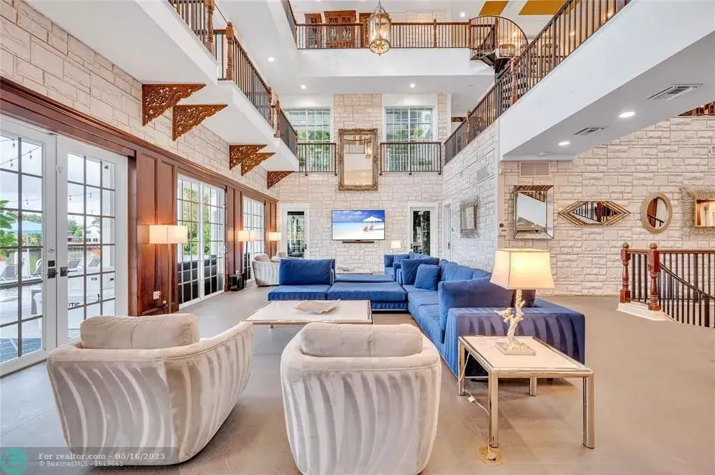 Front view of 1317 Middle River Dr showcasing sleek modern design and tropical landscaping in Fort Lauderdale