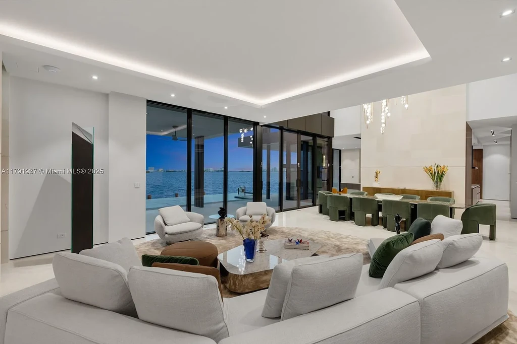 Exterior view of 11404 N Bayshore Dr, a $26.9M modern waterfront estate for sale in North Miami with bayfront dock, pool, and luxury tropical design.