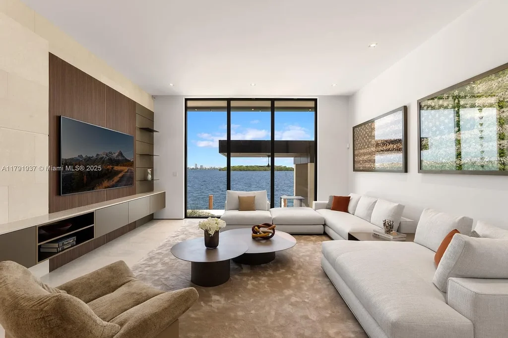Exterior view of 11404 N Bayshore Dr, a $26.9M modern waterfront estate for sale in North Miami with bayfront dock, pool, and luxury tropical design.