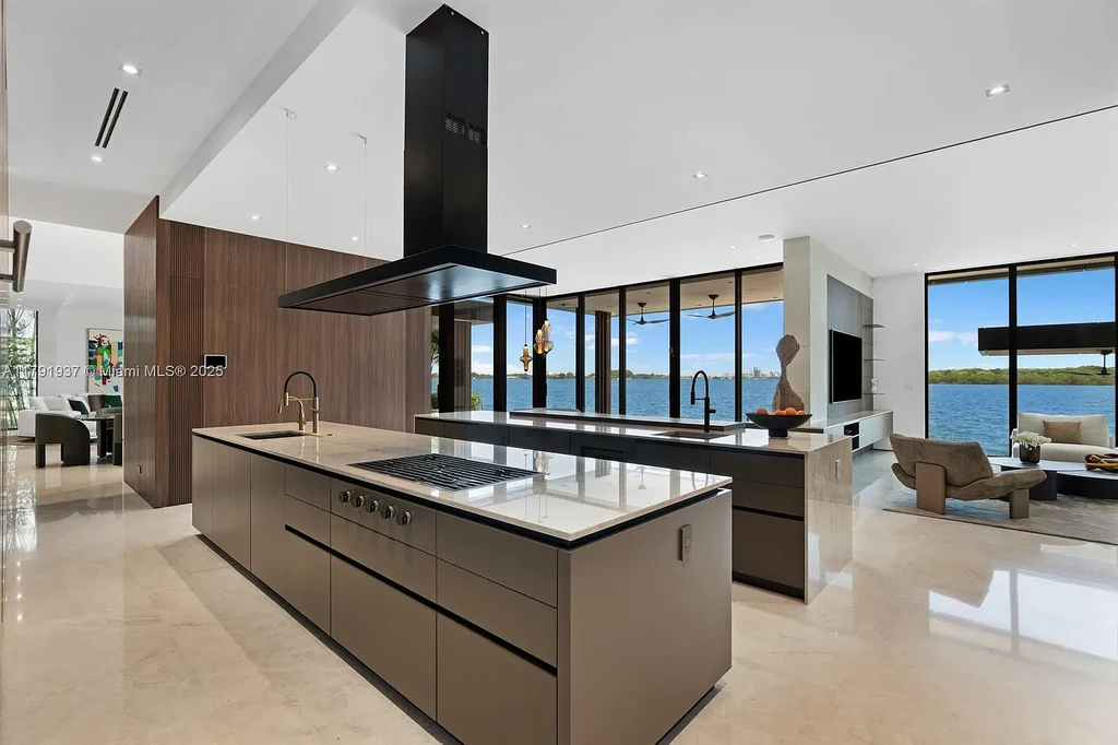 Exterior view of 11404 N Bayshore Dr, a $26.9M modern waterfront estate for sale in North Miami with bayfront dock, pool, and luxury tropical design.