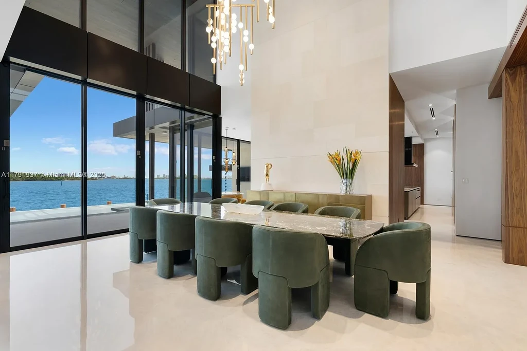 Exterior view of 11404 N Bayshore Dr, a $26.9M modern waterfront estate for sale in North Miami with bayfront dock, pool, and luxury tropical design.