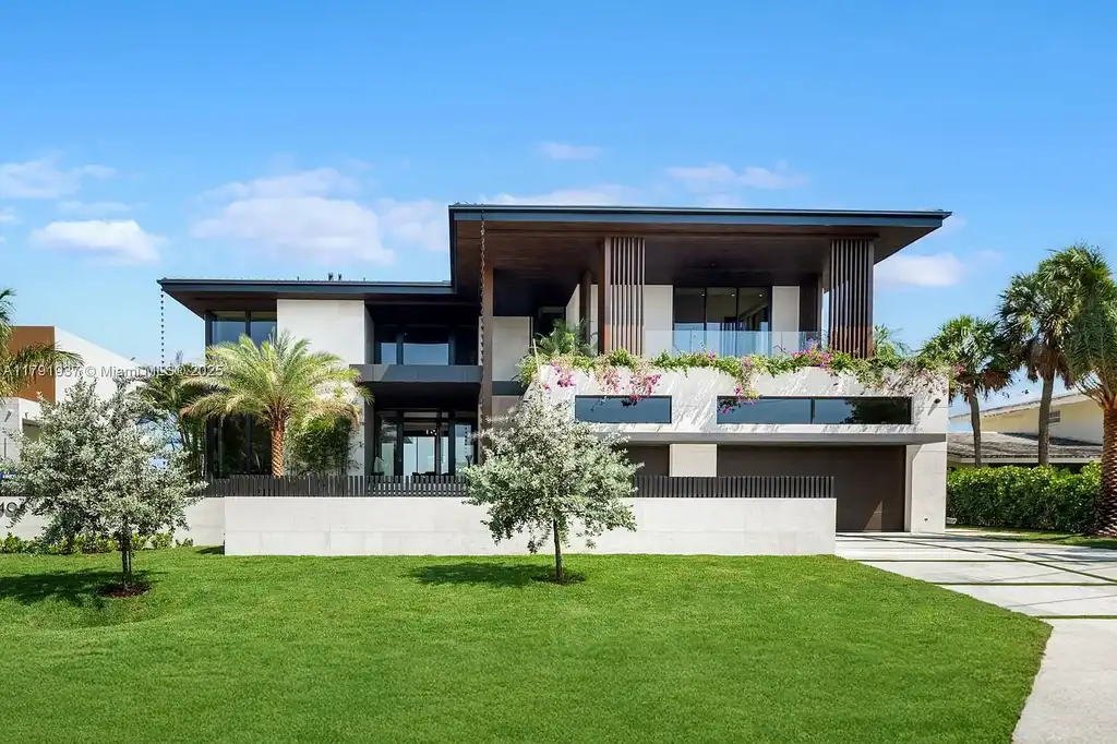 Exterior view of 11404 N Bayshore Dr, a $26.9M modern waterfront estate for sale in North Miami with bayfront dock, pool, and luxury tropical design.