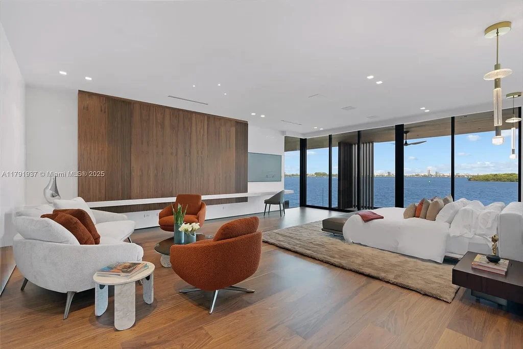 Exterior view of 11404 N Bayshore Dr, a $26.9M modern waterfront estate for sale in North Miami with bayfront dock, pool, and luxury tropical design.