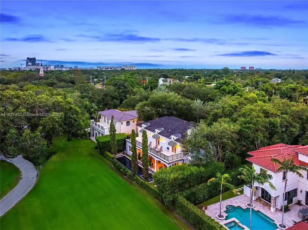 Front exterior view of 1171 Tiara Ct Coral Gables – a $5.1M luxury home with black-bottom pool, golf course views, and elegant Mediterranean-inspired architecture.