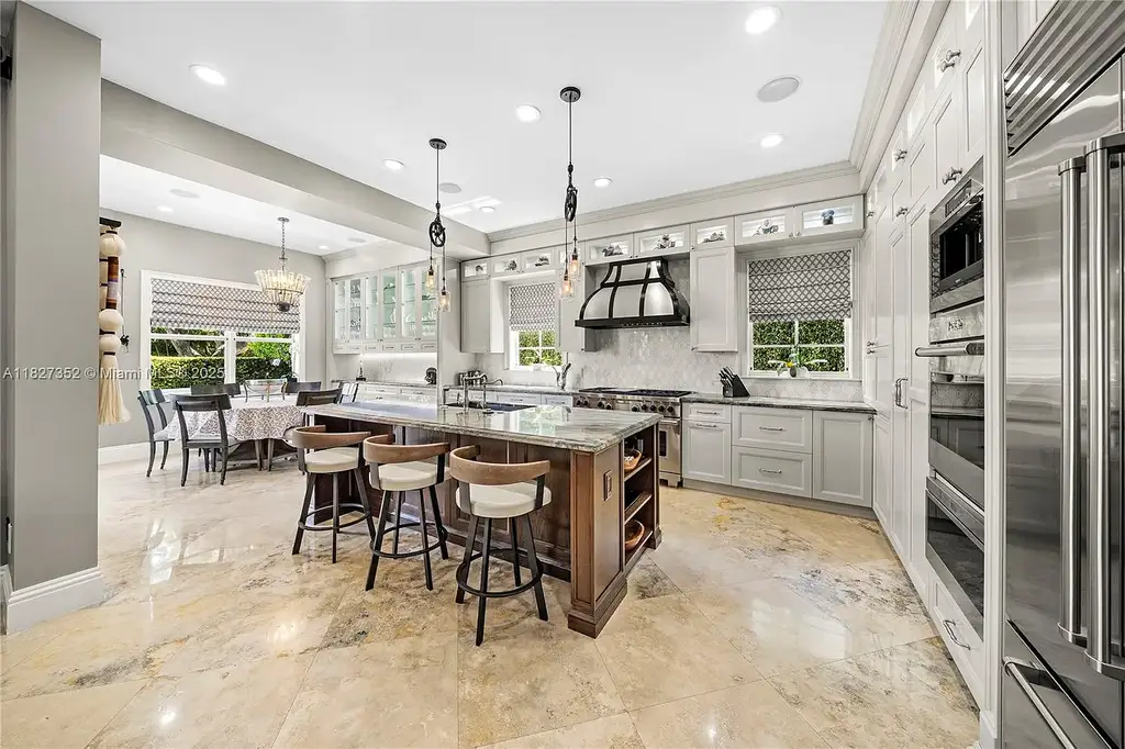 Front exterior view of 1171 Tiara Ct Coral Gables – a $5.1M luxury home with black-bottom pool, golf course views, and elegant Mediterranean-inspired architecture.