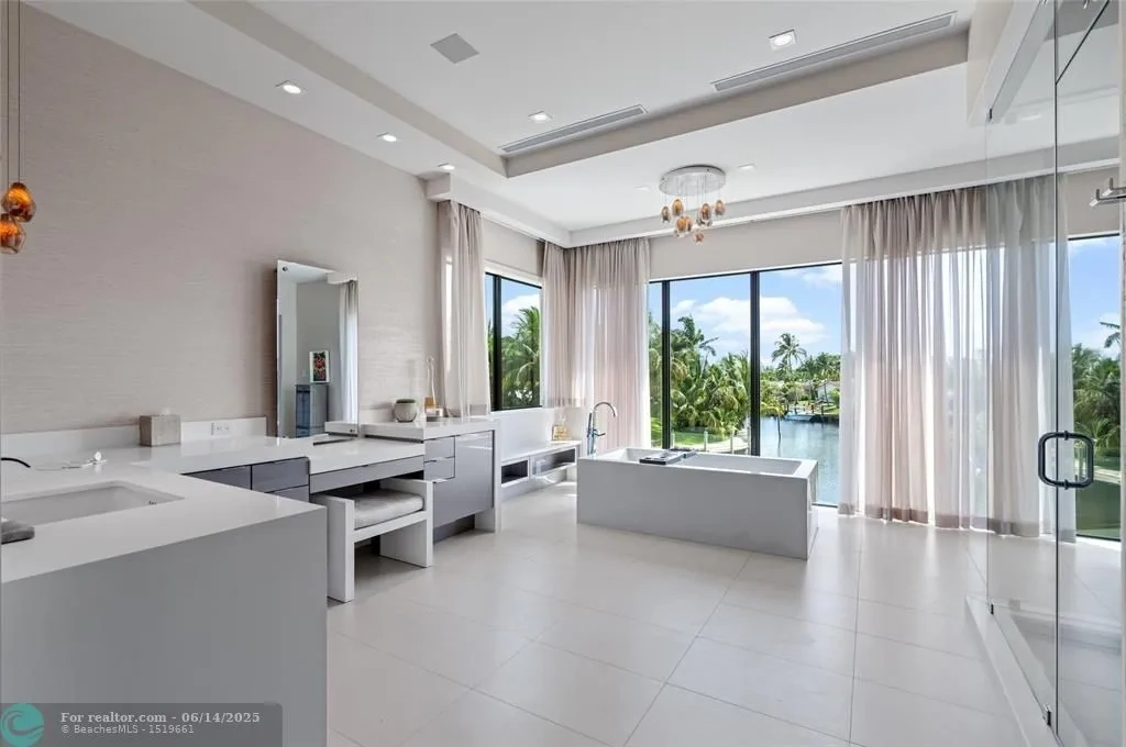 Aerial view of 1200 SE 12th Ter Deerfield Beach showcasing 245 ft waterfront, yacht dock, and saltwater pool.