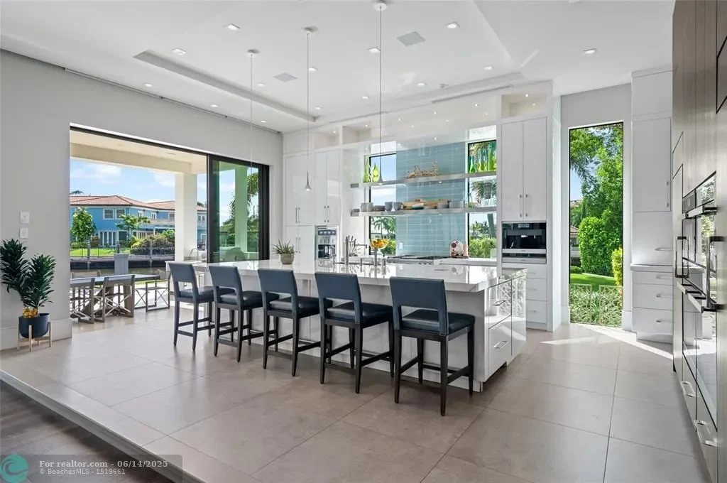 Aerial view of 1200 SE 12th Ter Deerfield Beach showcasing 245 ft waterfront, yacht dock, and saltwater pool.