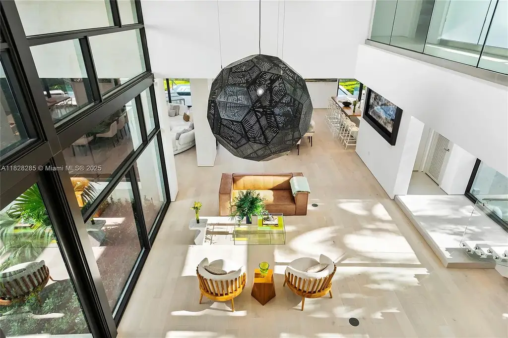 Modern waterfront home at 1410 S Biscayne Point Rd featuring limestone façade, private saltwater pool, and 75 feet of bay frontage in Miami Beach.