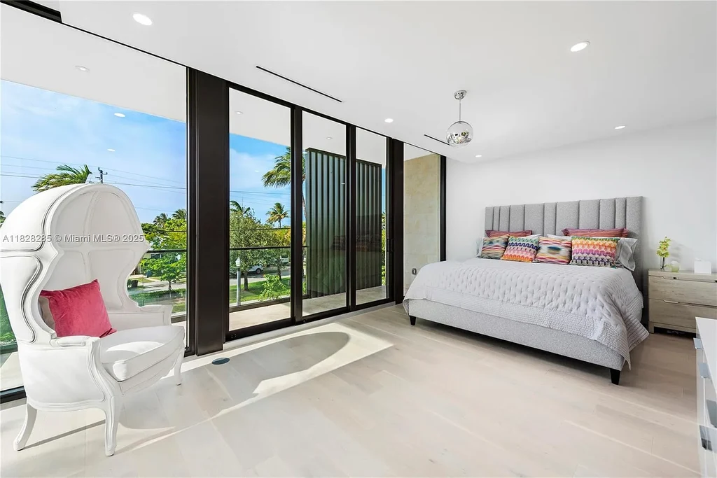 Modern waterfront home at 1410 S Biscayne Point Rd featuring limestone façade, private saltwater pool, and 75 feet of bay frontage in Miami Beach.